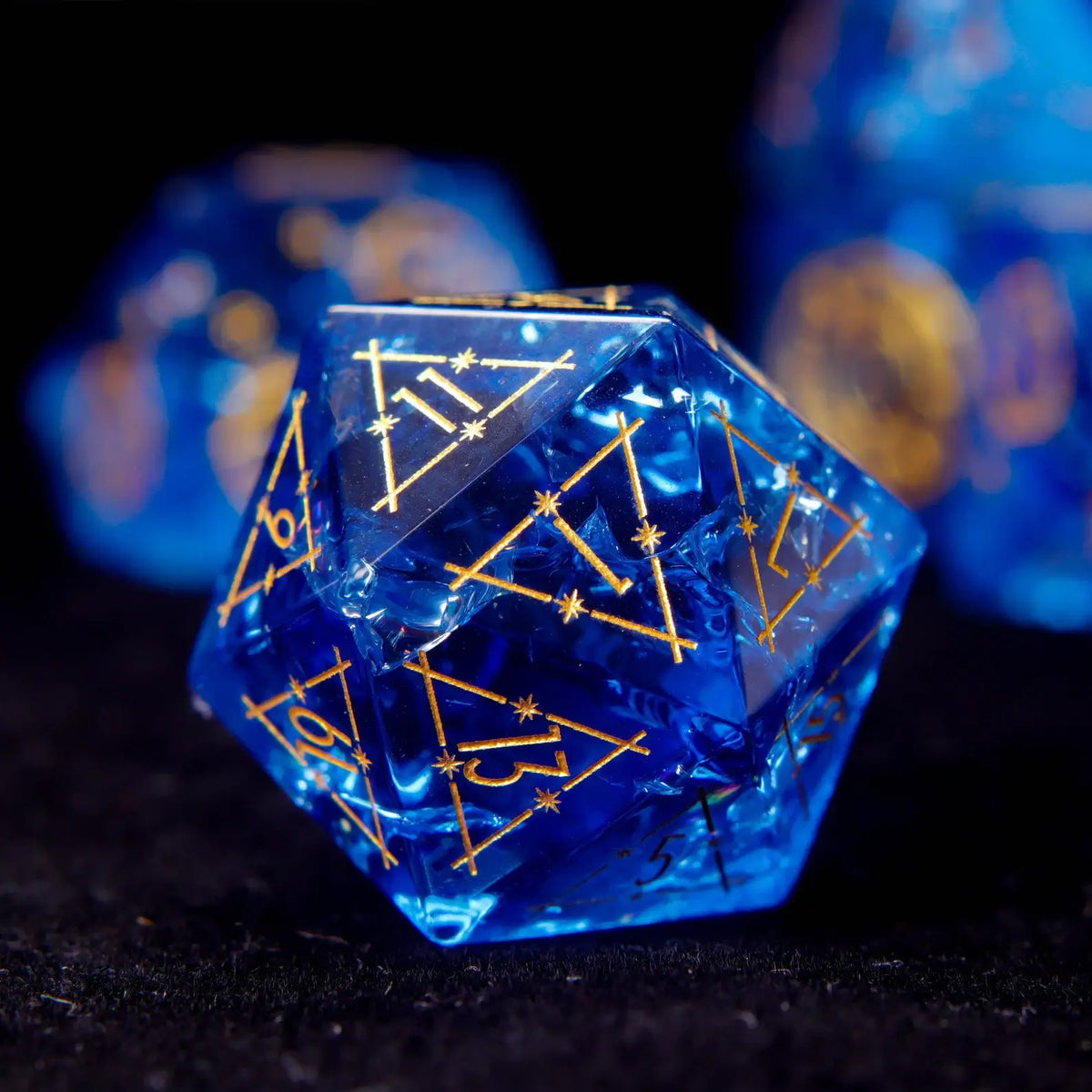 Blue glass sharp edge D20 with gold constellation pattern and gold numbers