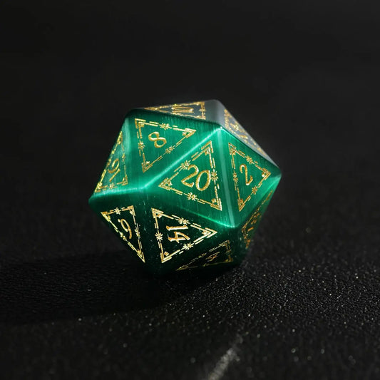 Close-up of a single Dare Green Cat's Eye Gemstone Dice D20 with Gold Inking, a handcrafted DND polyhedral die on a black background, highlighting the intense green and gold contrast.