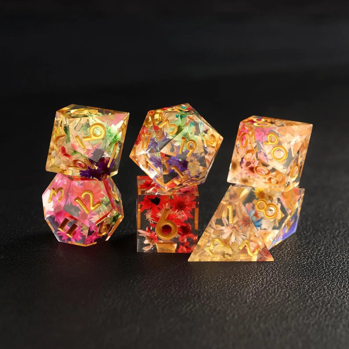 The complete 7-piece Transparent Floral DND Resin Dice Set arranged together, showcasing the delicate flower designs in each die, perfect for collectors and RPG players.