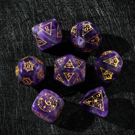 Top view of a Natural Amethyst dice set with gold engraved numbers