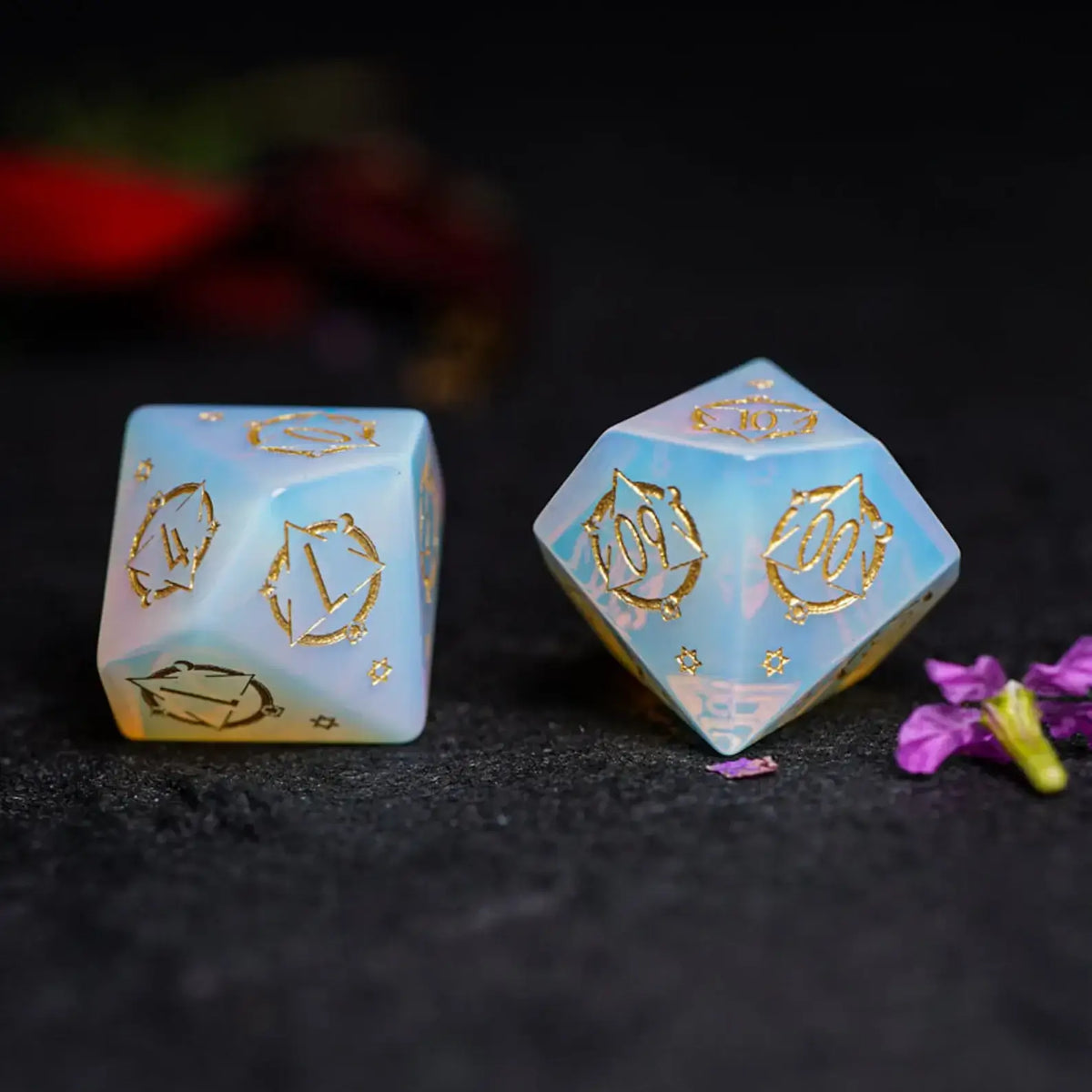 Engraved Opalite percentile D10 die with celestial symbols for RPG gameplay.