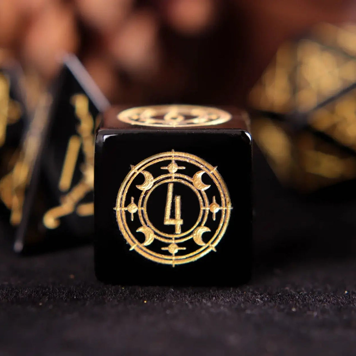 Single hand-carved black Obsidian D6 dice showing sharp edges and smooth handfeel for DND gameplay