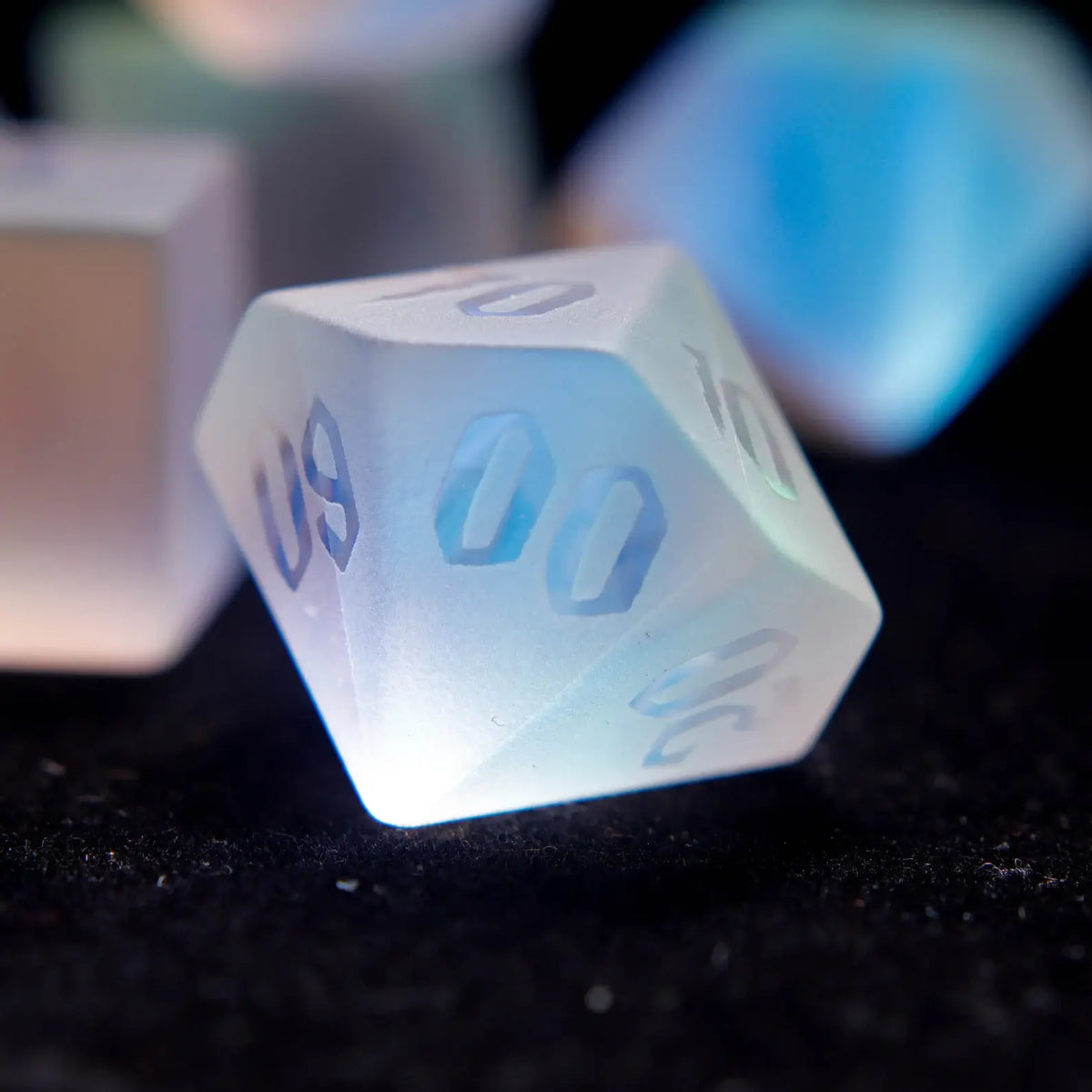 player holding a frosted dichroic glass d%, emphasizing the premium tactile feel of the matte surface and raised numbering.