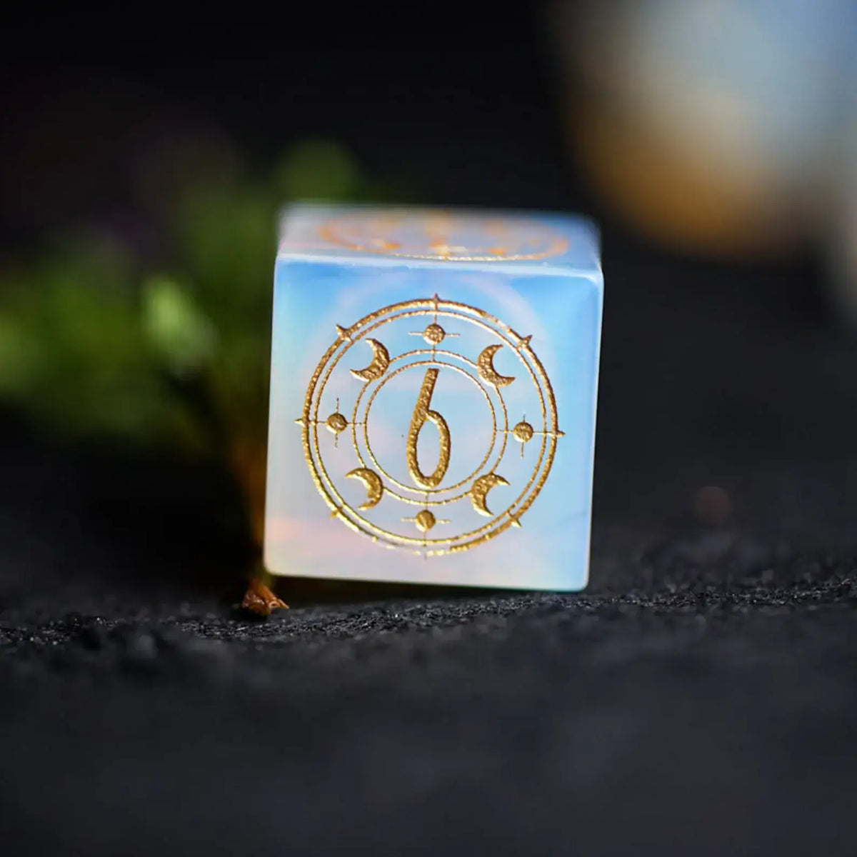Single Opalite D4 die engraved with star and moon astrology symbols for D&D.