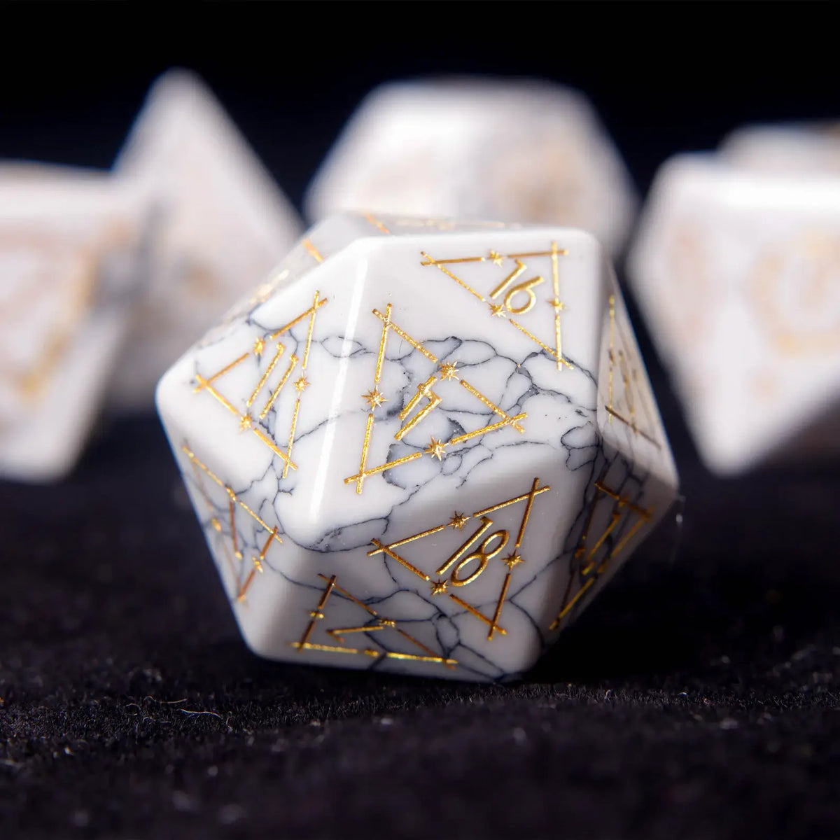 Extreme close-up of a single White Howlite D20 die showing deep engraved numbers.