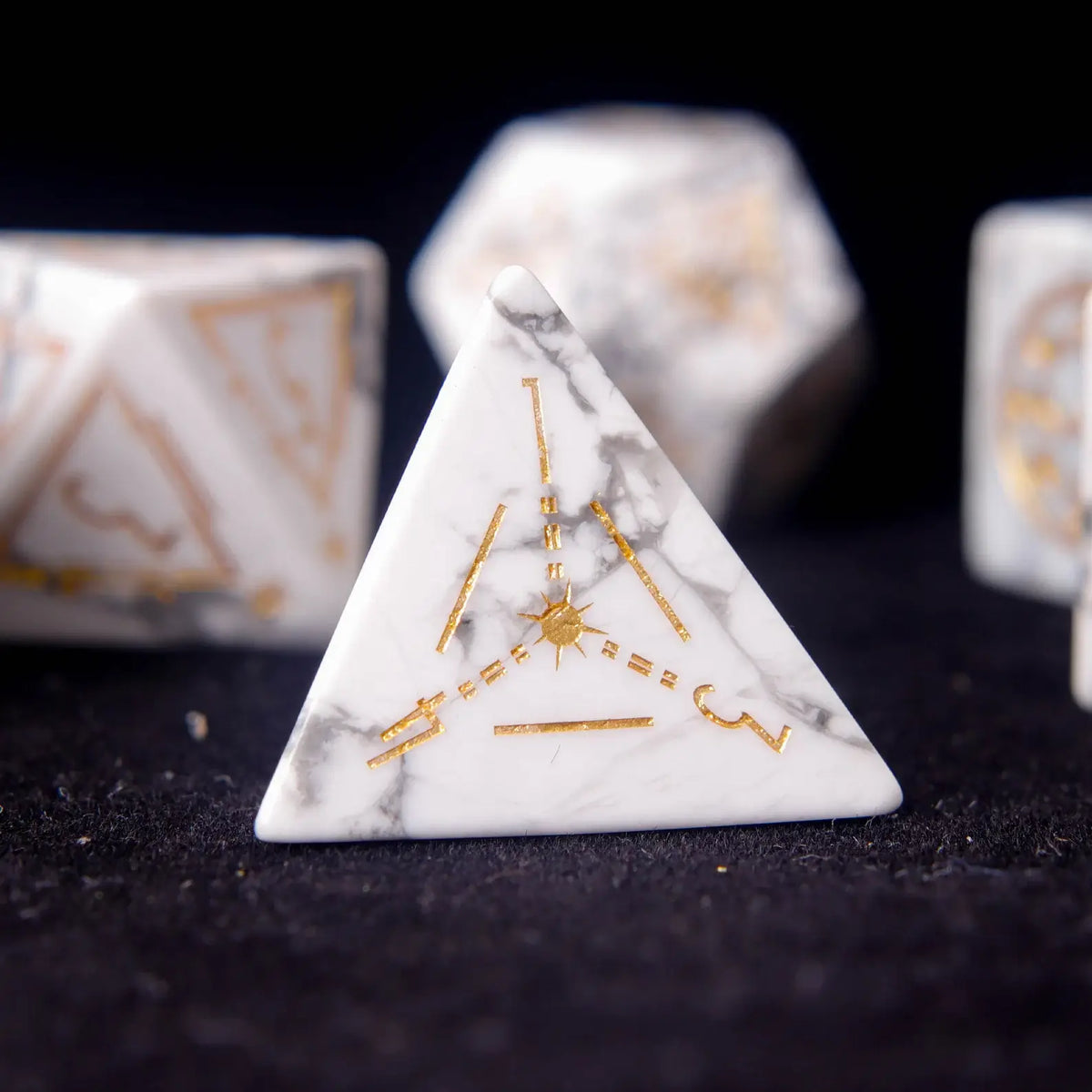 Single White Howlite D4 die standing upright to display its pyramid form.