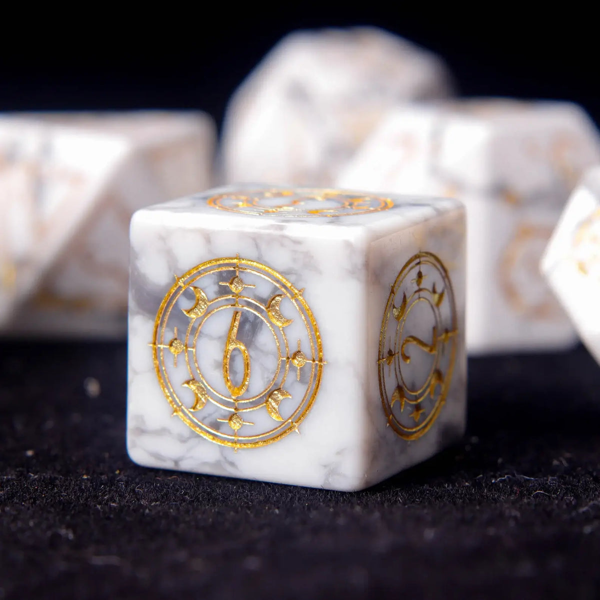 Close-up of engraved pips on a White Howlite D6 die.
