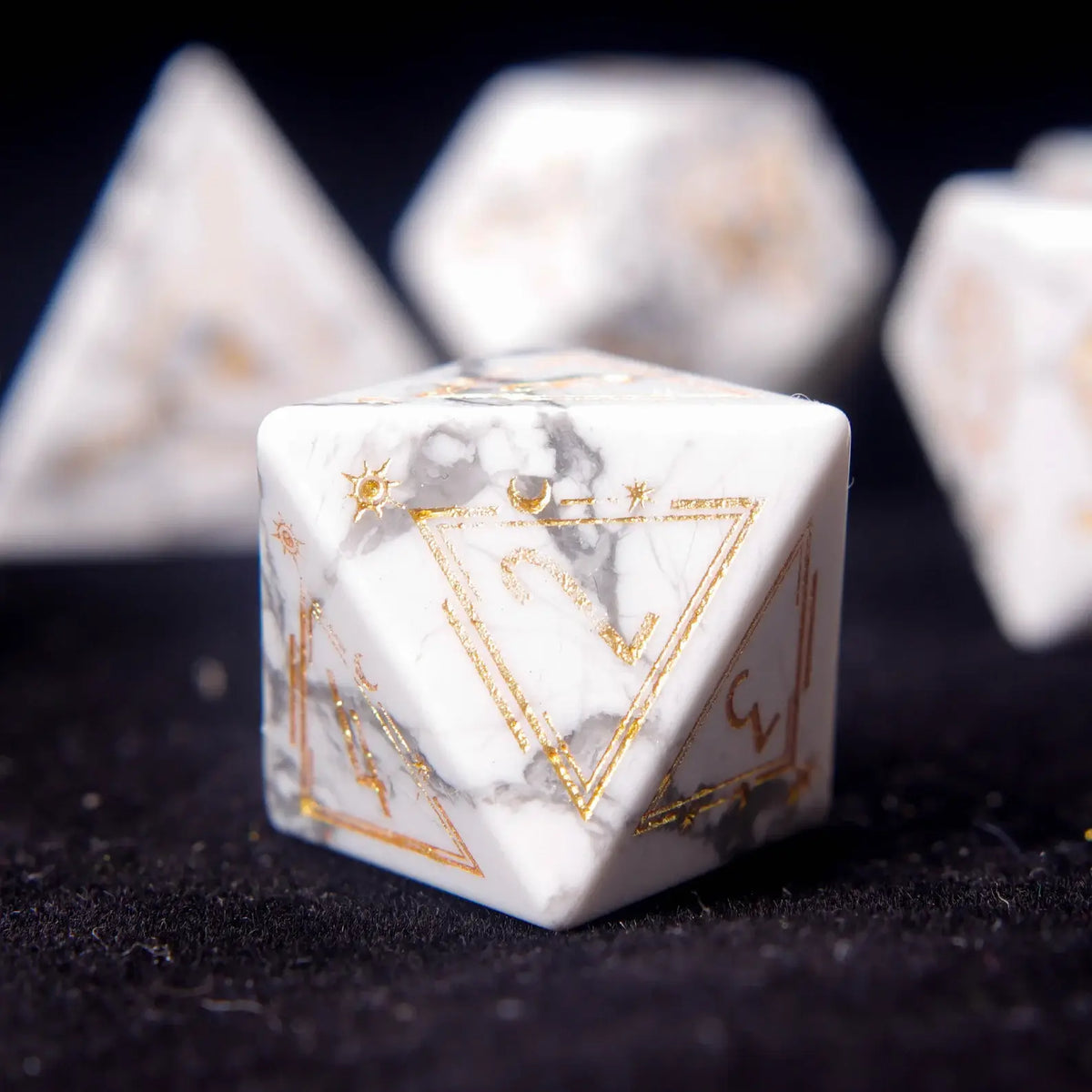 Contrast shot of White Howlite dice arranged on a dark leather notebook.