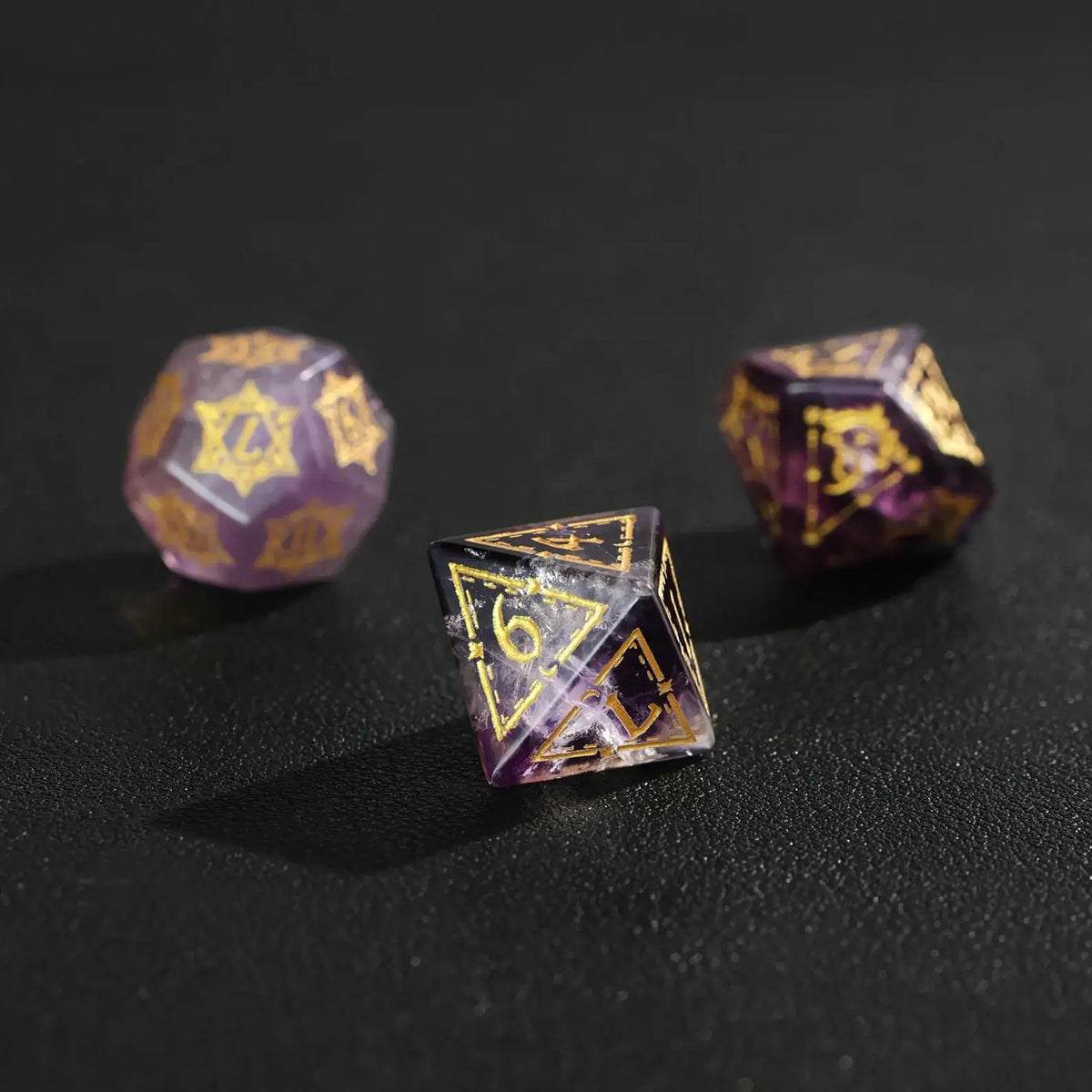 An angled photo of the Purple Fluorite DND Dice Set catching the light, emphasizing the vivid purple color and polish.