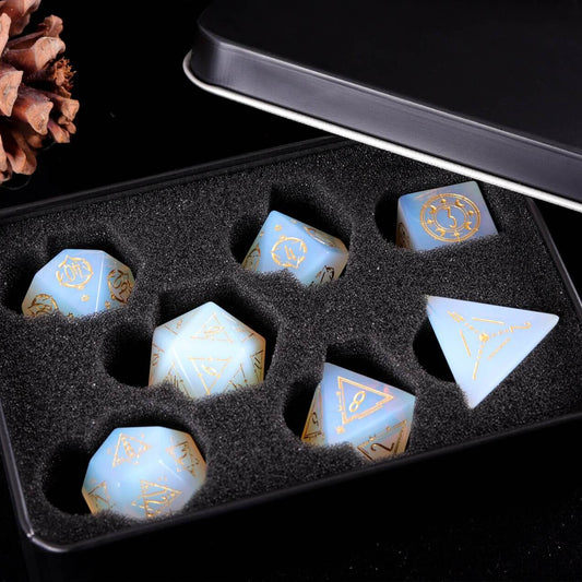 White carved opal dice set presented alongside a protective carrying case.