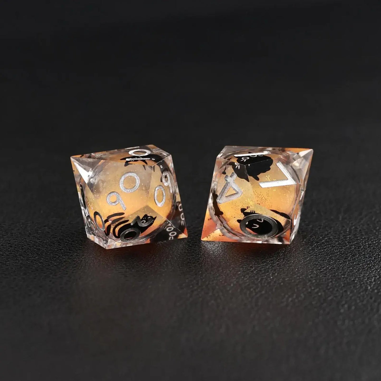 The mesmerizing swirling liquid core effect in the Orange Swirl Resin Set dice, with a cat animal dice accent.