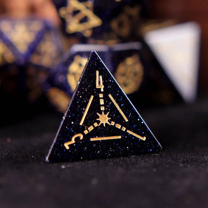 A set of D4 blue sandstone gemstone-carved dice on a black background