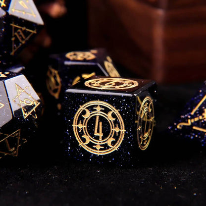 A set of D6 blue sandstone gemstone-carved dice on a black background