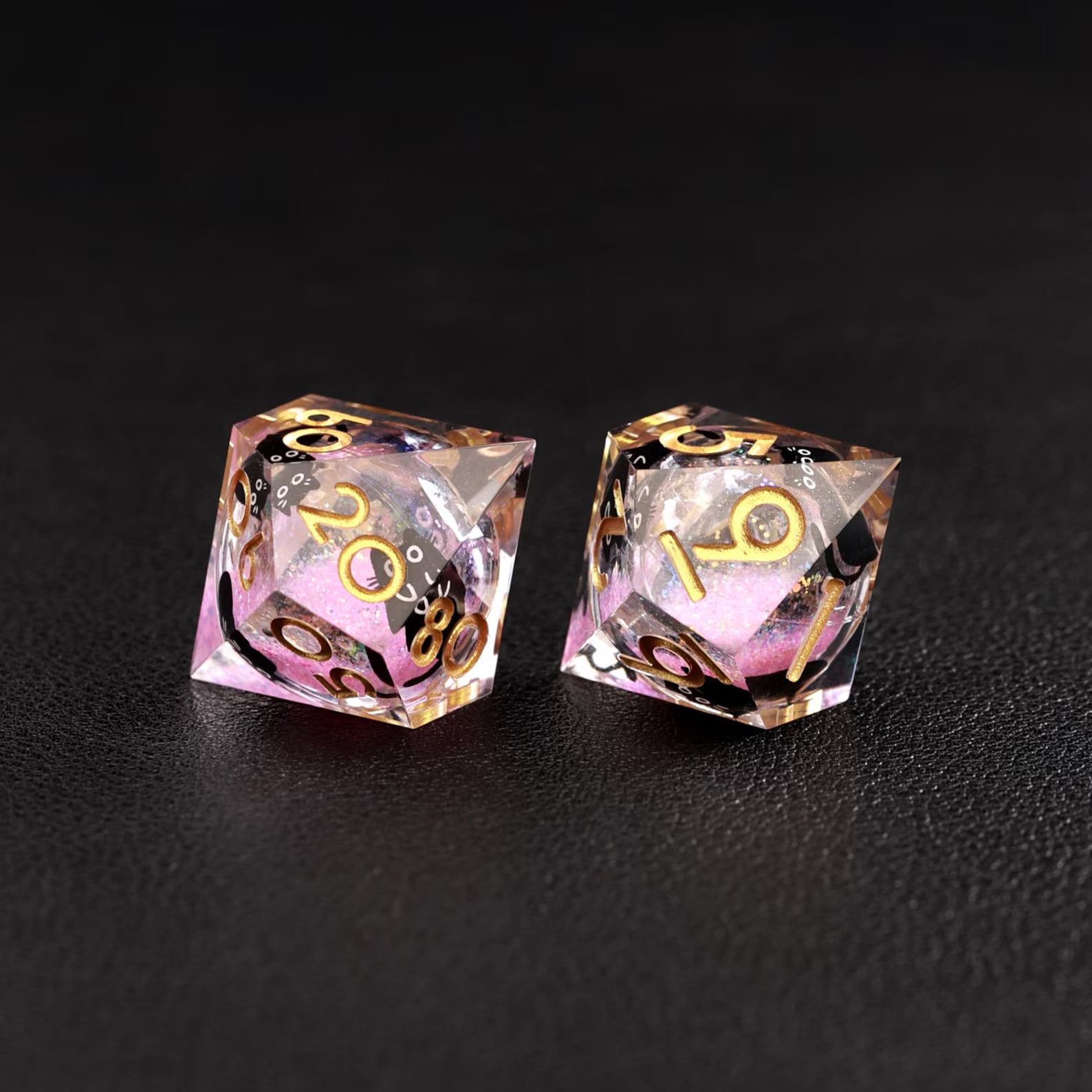 Detailed shot of the black cat animal dice suspended in the dynamic Liquid Core Dice center, set against pink swirls.