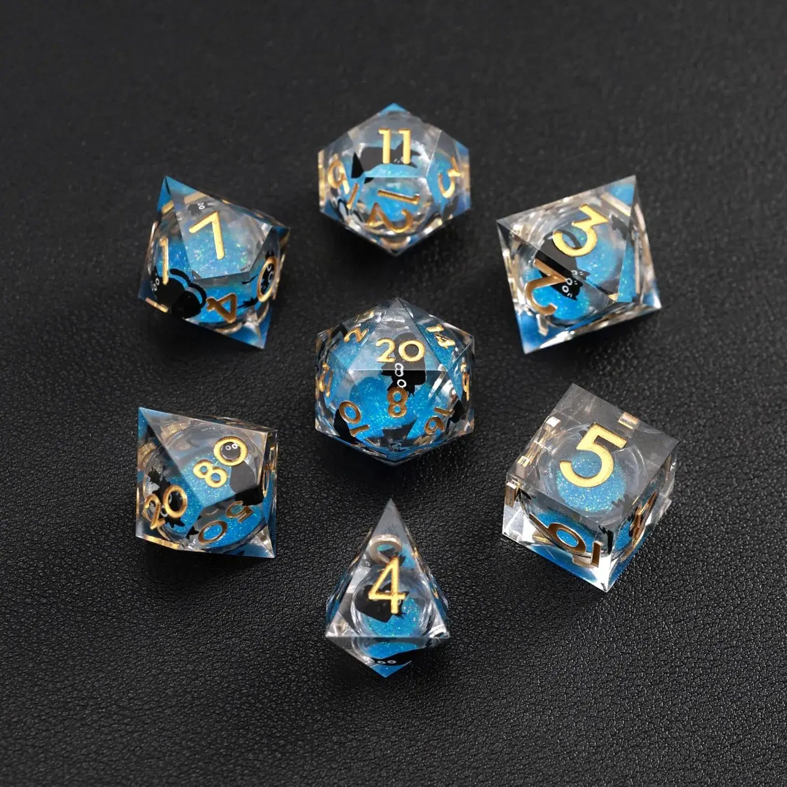 Close-up of Blue Swirl Liquid Core Dice Resin Set featuring the black cat animal dice inclusion.