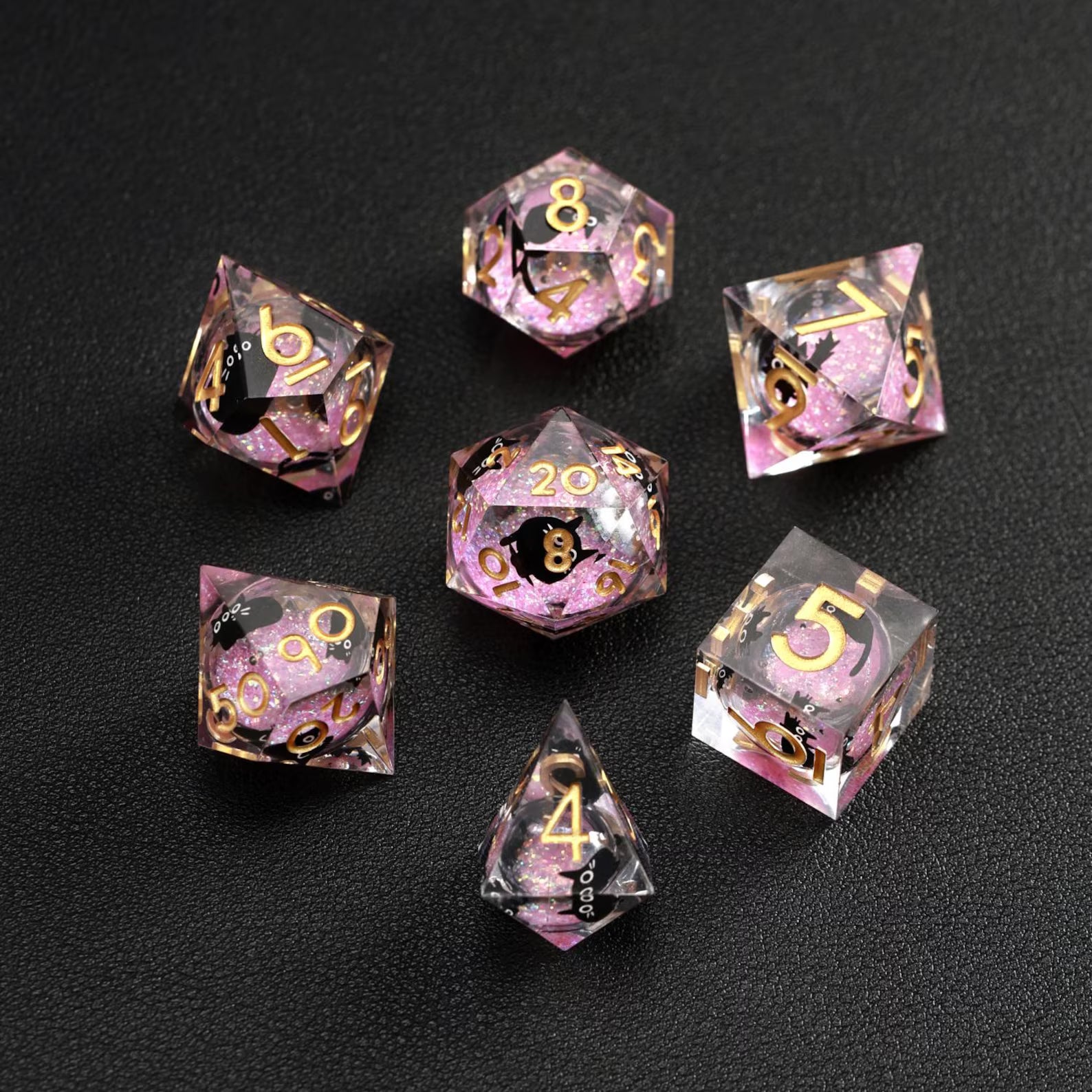 Close-up of Pink Swirl Liquid Core Dice Resin Set, featuring the black cat animal dice inclusion.