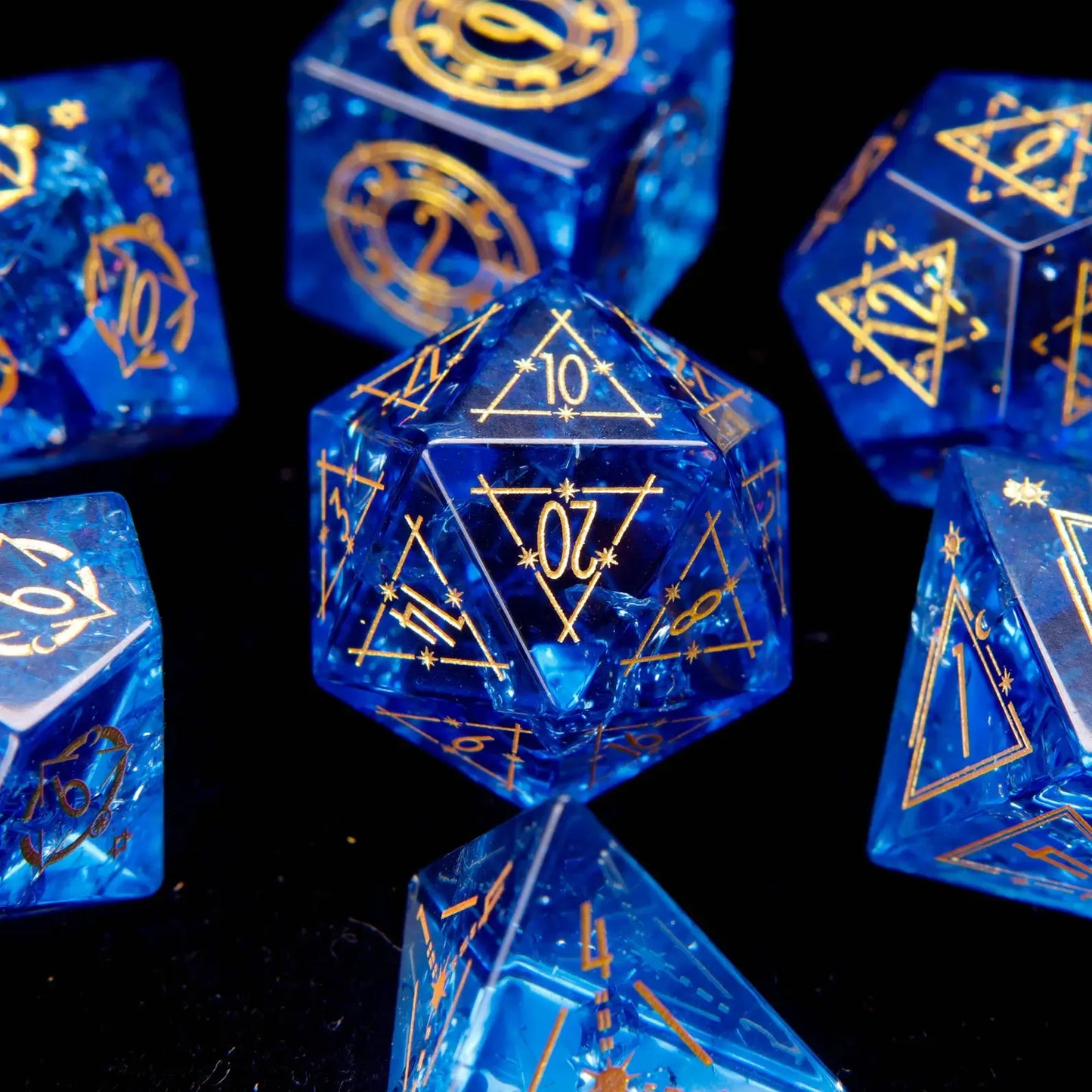 Complete set of 7 Blue Glass Sharp Edge DND Dice with a starry style. Crystal-clear glass with internal sparkles mimics a starry sky.