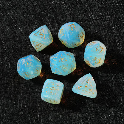 Sky Blue Opalite Glass Dice Set, close-up of two polyhedral dice with gold celestial numbers