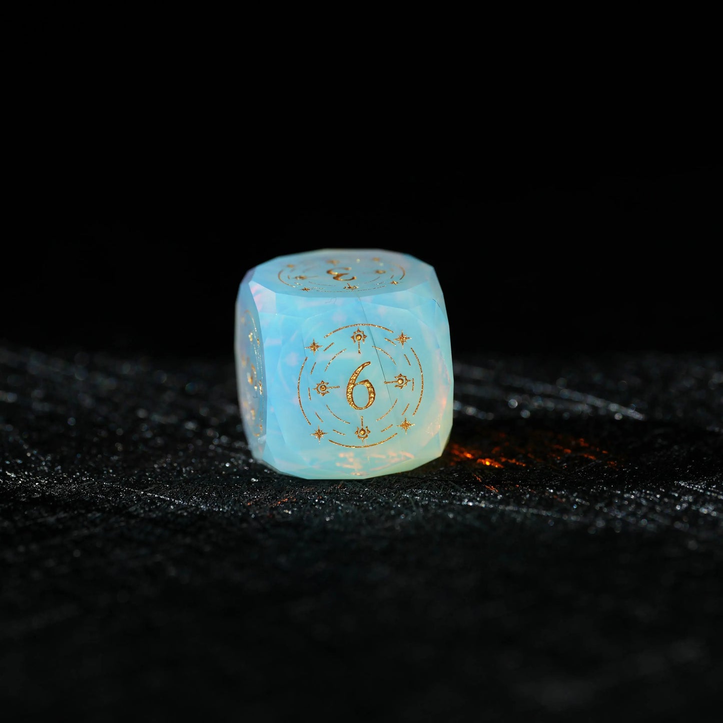 Sky Blue Opalite Glass Dice Set, close-up of a d6 showing ornate gold celestial engraving