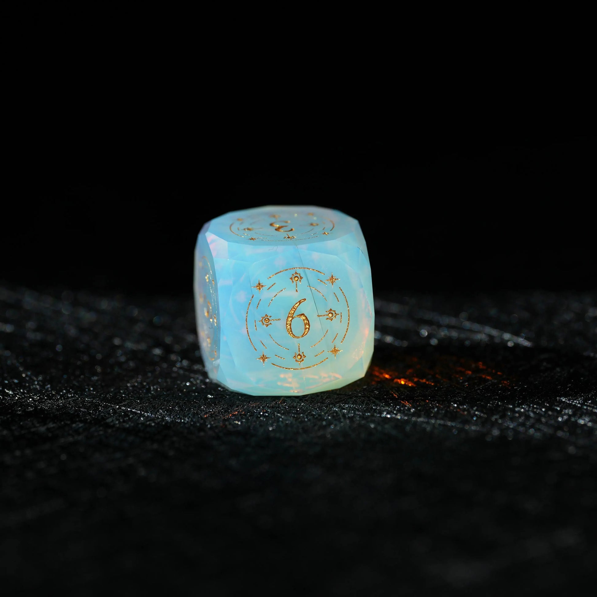 Sky Blue Opalite Glass Dice Set, close-up of a d6 showing ornate gold celestial engraving