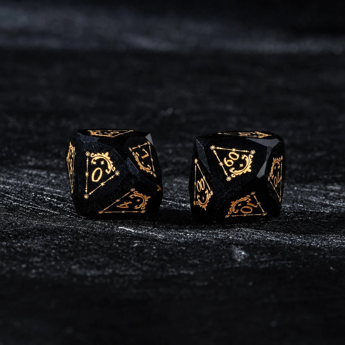 Celestial Black Obsidian Dice Set, close-up of two polyhedral dice with gold celestial numbers
