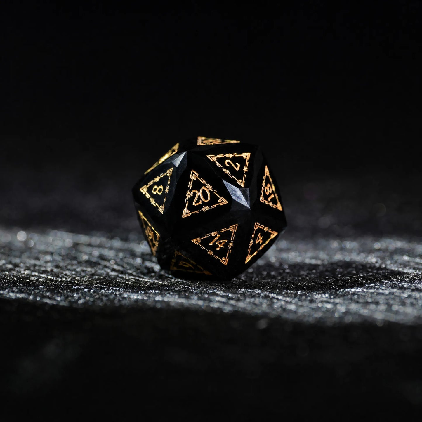 Celestial Black Obsidian Dice Set, single d20 on a dark tabletop background