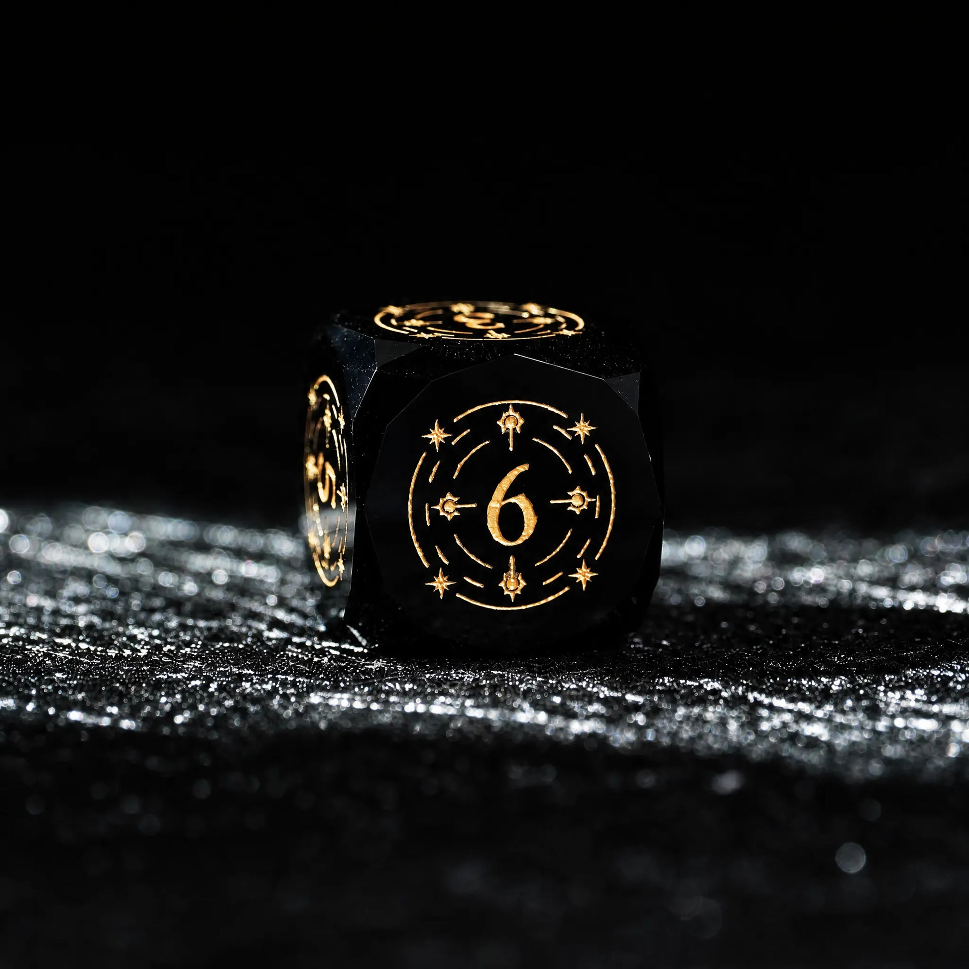 Celestial Black Obsidian Dice Set, close-up of a d6 showing ornate gold celestial engraving
