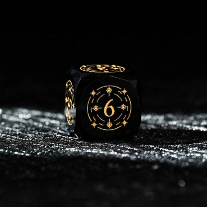 Celestial Black Obsidian Dice Set, close-up of a d6 showing ornate gold celestial engraving