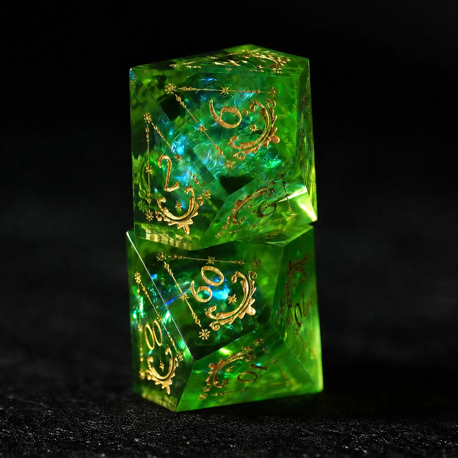 Emerald Cosmic Foil Sharp Edge Resin Dice Set, two dice stacked to show transparent color and gold engraving