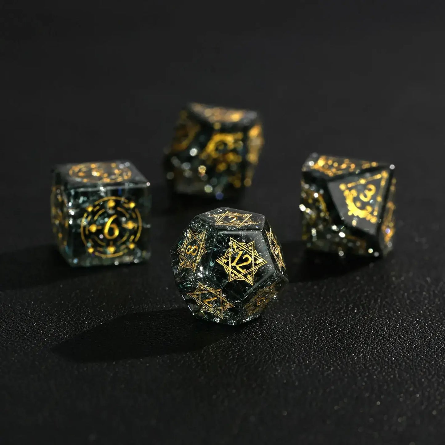 A close-up of the D12 and D10 dice, focusing on their high transparency and the clear, silver-inked numbers against a blurred background.