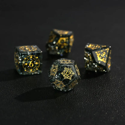 A close-up of the D12 and D10 dice, focusing on their high transparency and the clear, silver-inked numbers against a blurred background.