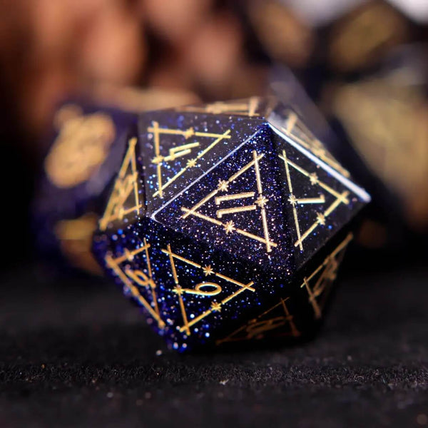A D&D blue sandstone gemstone engraved die, D20, on a black background.