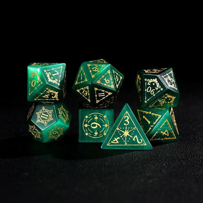 The complete 7-piece Dare Green Cat's Eye Gemstone Dice Set (D4-D20) with Gold Inking fully displayed on a black background, the essential Polyhedral Dice collection.