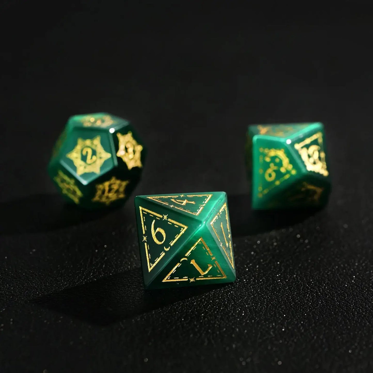Group of three Dare Green Cat's Eye Gemstone Dice (e.g., D8, D10, D%) with Gold Inking, perfect for a DND Polyhedral Dice collection on a dark background.
