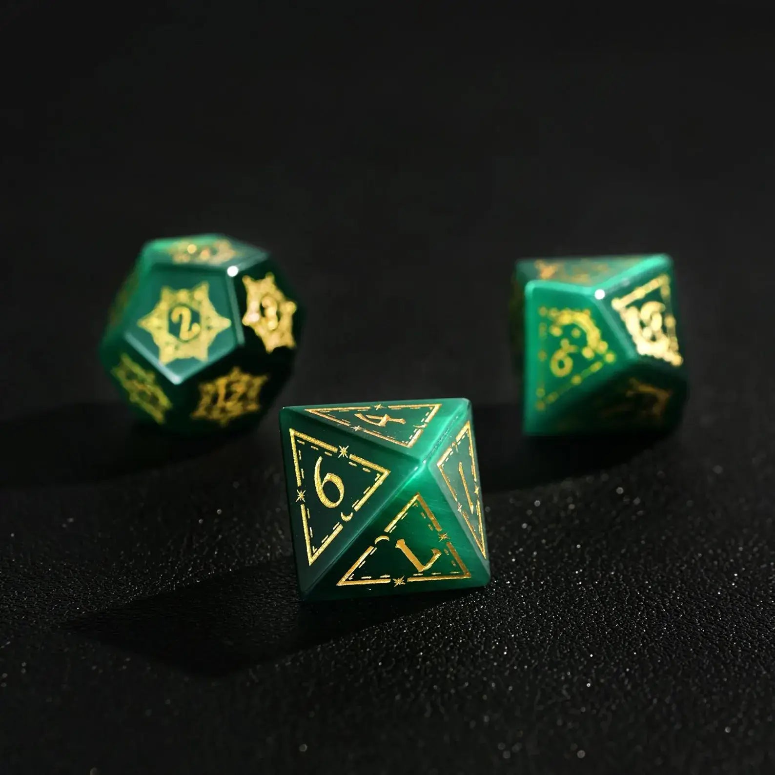 Group of three Dare Green Cat's Eye Gemstone Dice (e.g., D8, D10, D%) with Gold Inking, perfect for a DND Polyhedral Dice collection on a dark background.