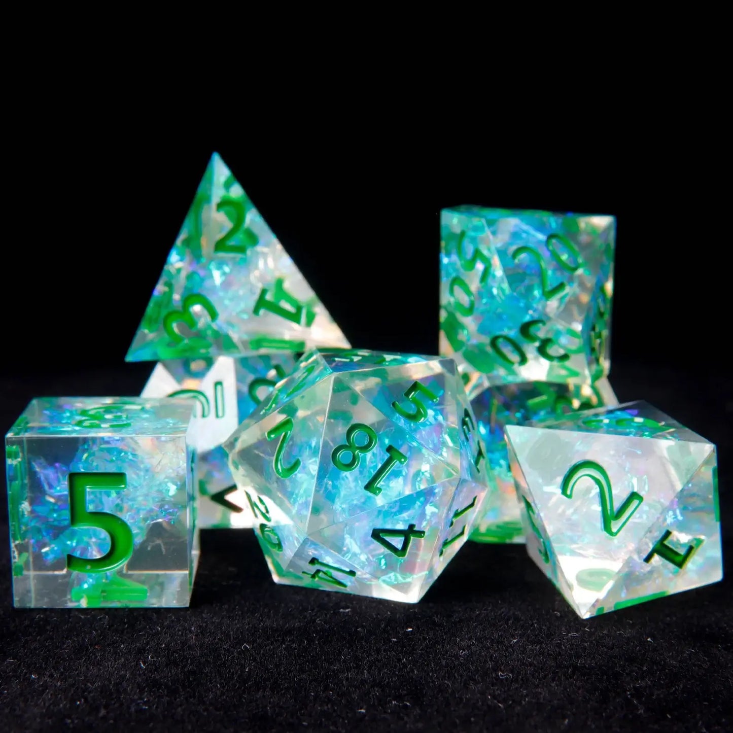 A Green Sharp Edge D20 die featuring custom engraving, adding a personalized touch to this striking RPG dice set.