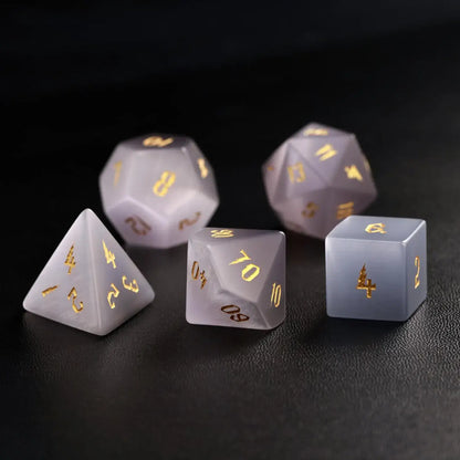 Five pieces of high-quality Grey Cat's Eye Gemstone Dice displayed together, focusing on the luxury feel and precise numerical engraving.