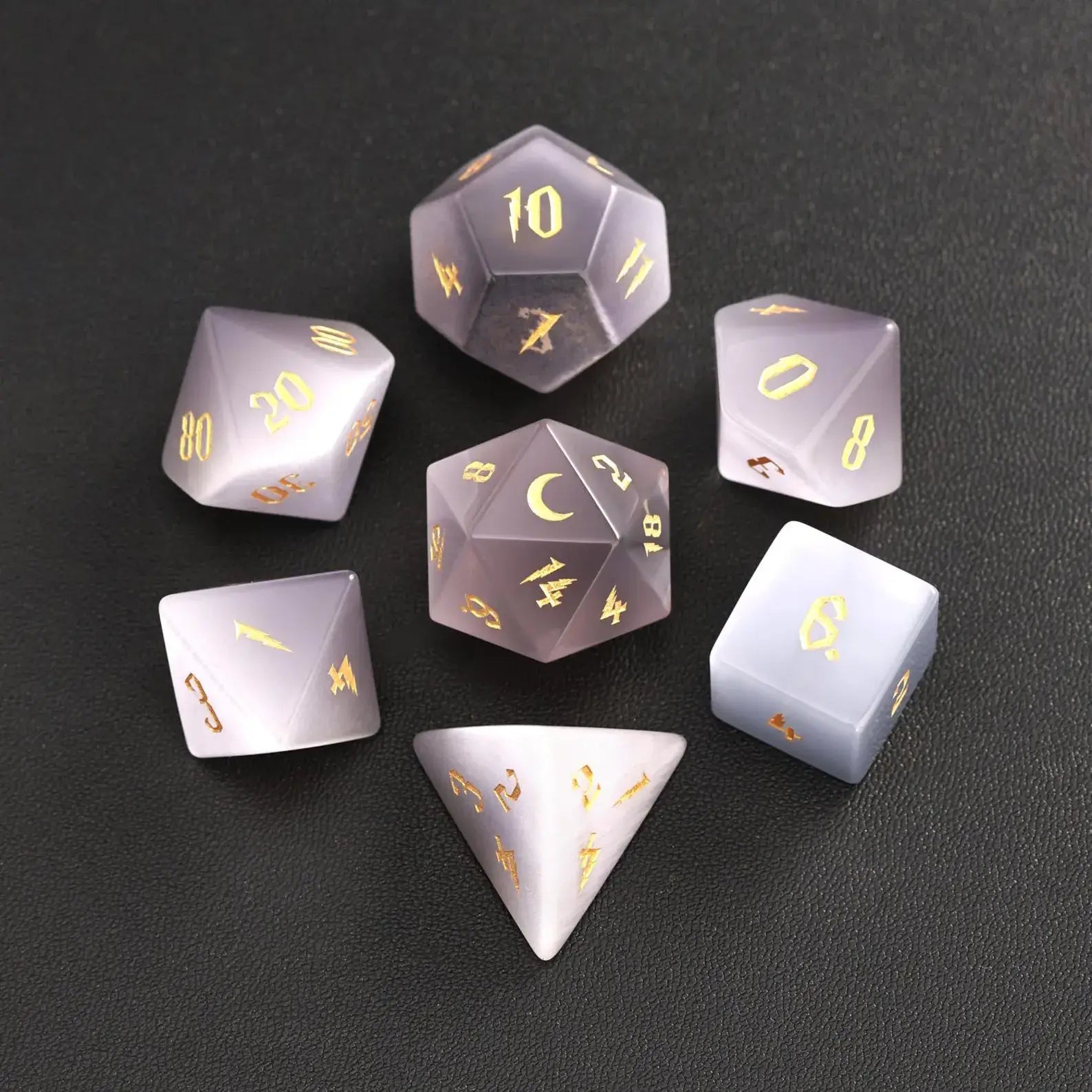 The complete 7-piece Grey Cat's Eye Gemstone Dice Set (D4-D20) fully displayed on a black background, the essential Polyhedral Dice collection.