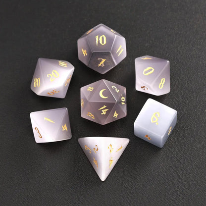 The complete 7-piece Grey Cat's Eye Gemstone Dice Set (D4-D20) fully displayed on a black background, the essential Polyhedral Dice collection.