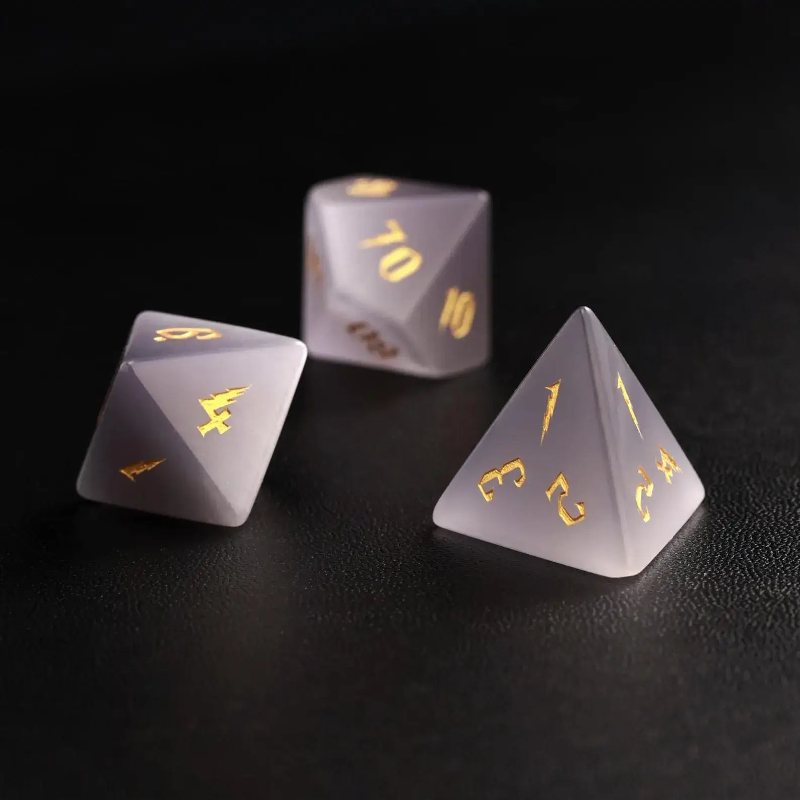 Group of three Grey Cat's Eye Gemstone Dice (e.g., D8, D10, D%) arranged together, perfect for a DND Polyhedral Dice collection on a dark background.