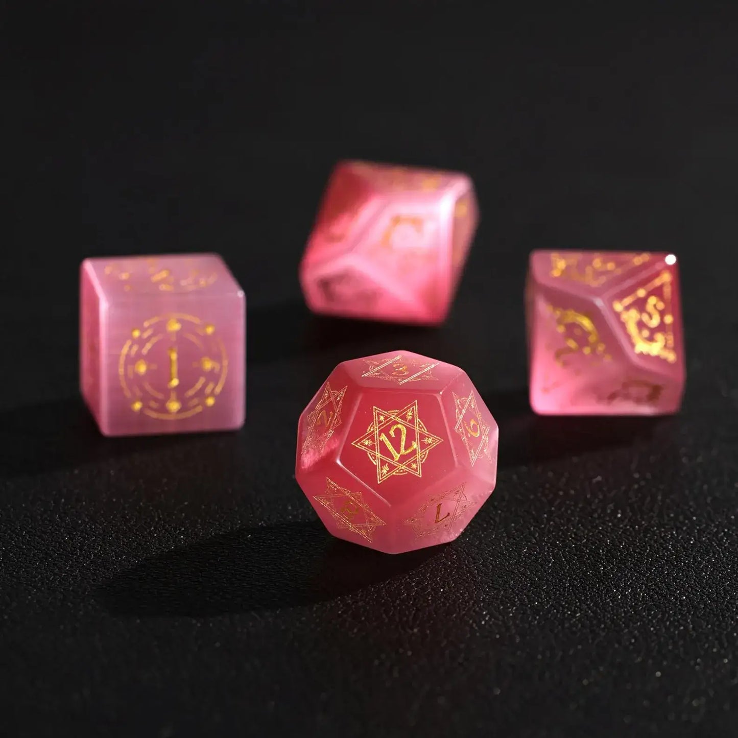 Detailed shot of a luxury Pink Cat's Eye D12 Gemstone Dice, showcasing its smooth stone finish and unique internal patterns for TTRPG gameplay.