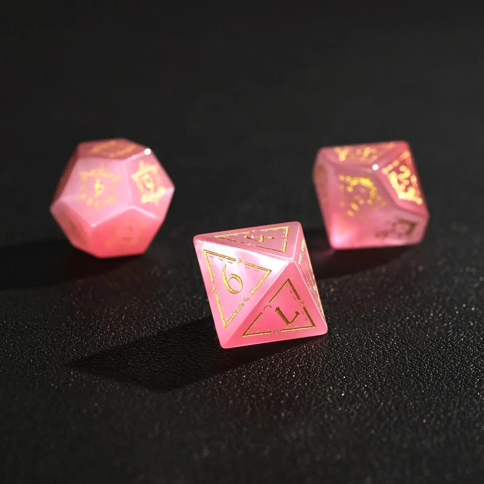 Group of three Pink Cat's Eye Gemstone Dice (e.g., D8, D10, D%) arranged together, perfect for a DND Polyhedral Dice collection on a dark background.