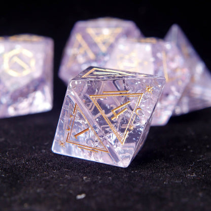 Macro view of the sharp point of the Pink Glass D4. Focus on the precise cut and sharp aesthetic of the sharp edge dice.