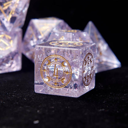 Three Pink Glass D6 dice side-by-side, emphasizing the clear gold numbers and the intricate demon eye engraving.