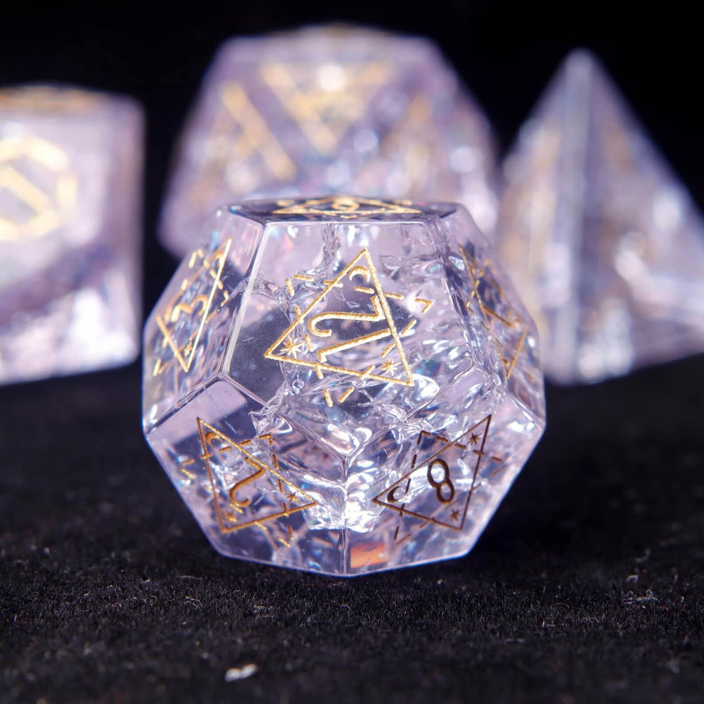 Pink Glass Sharp Edge RPG Dice Set scattered across a pure black background. Shows the luxury finish and light reflection of the dice.