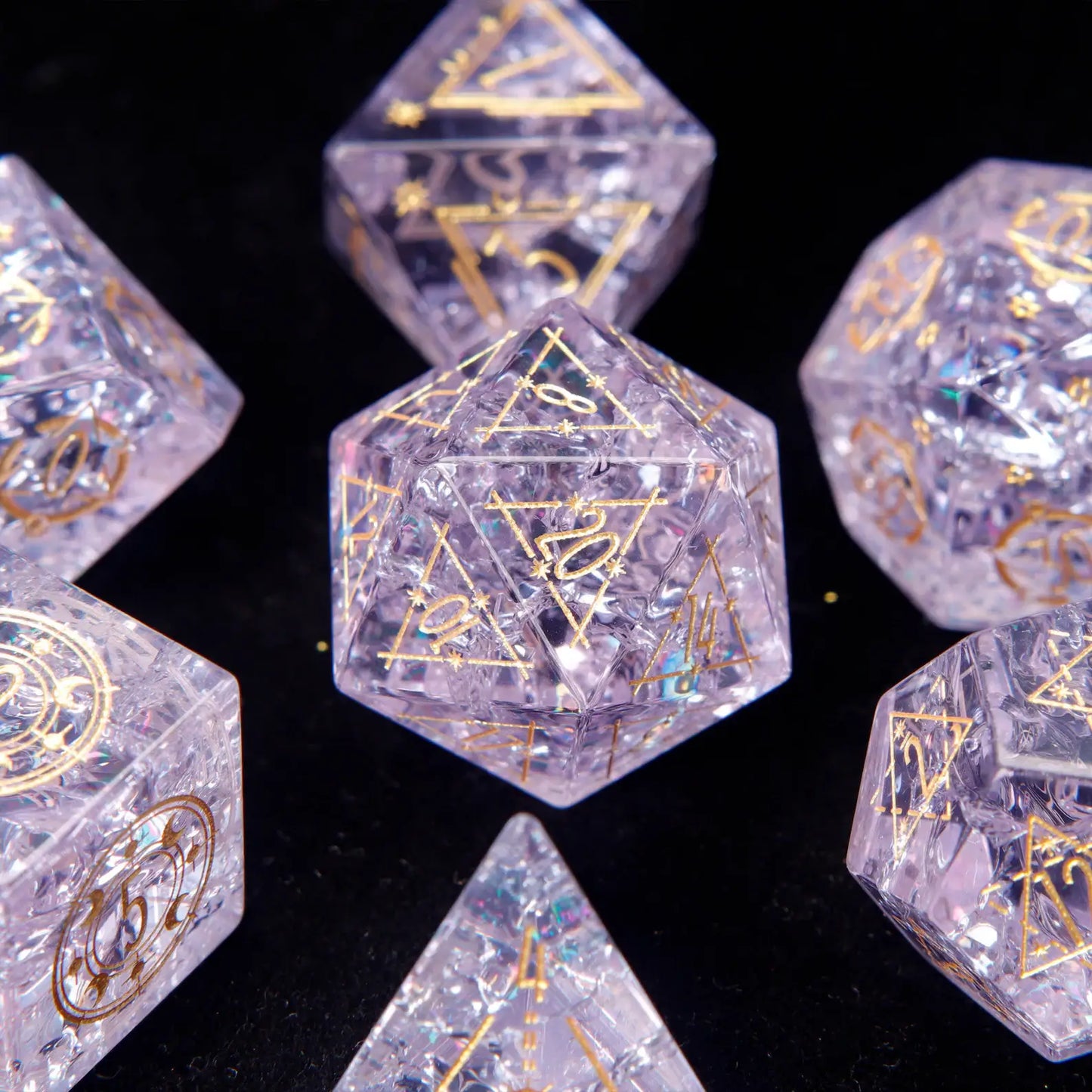 Full polyhedral set of Pink Glass Sharp Edge DND Dice on a black background. Highlighting the gold numbers and crystal clarity.