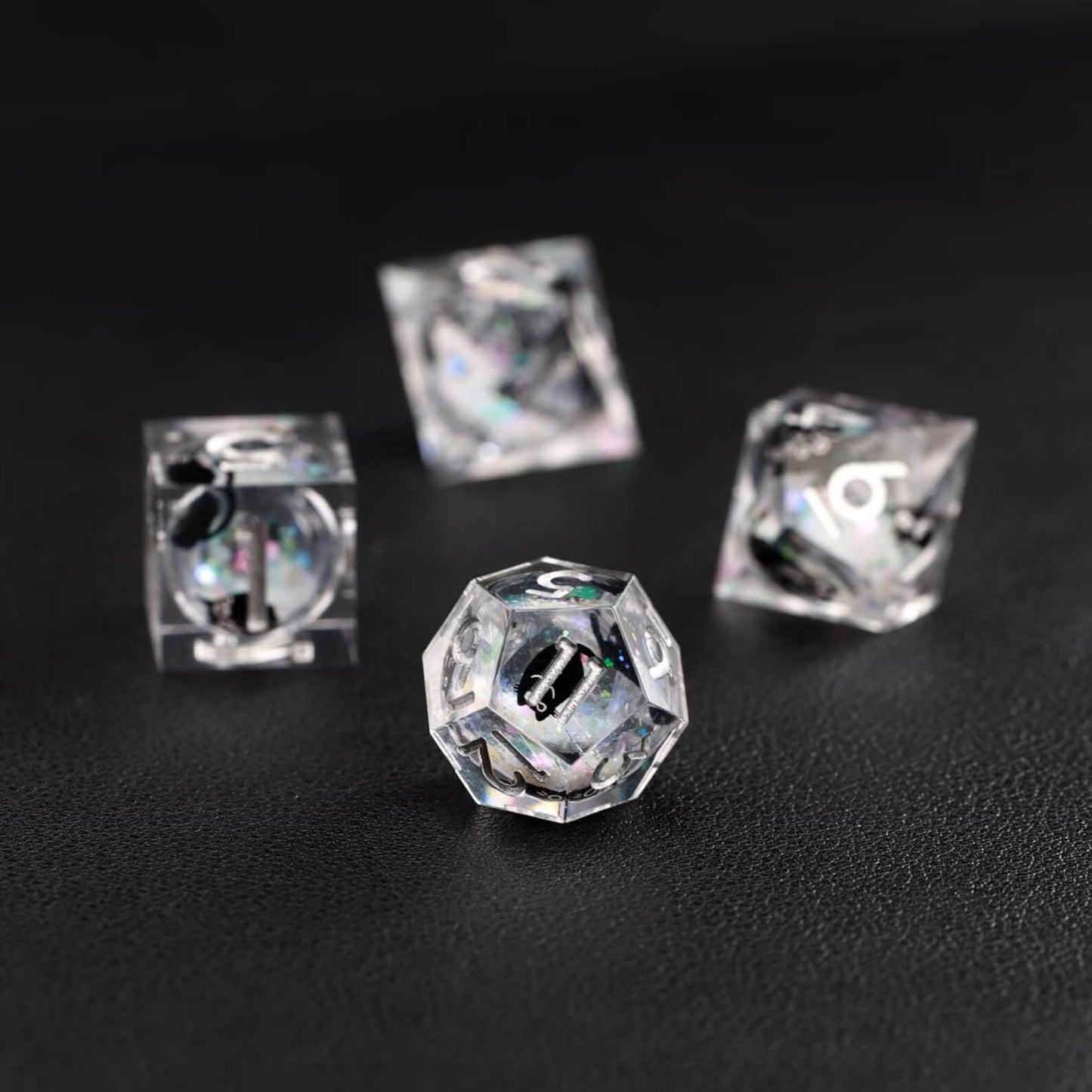 Assortment of polyhedral shapes in the Liquid Core Dice Resin Set with the animal dice feature.