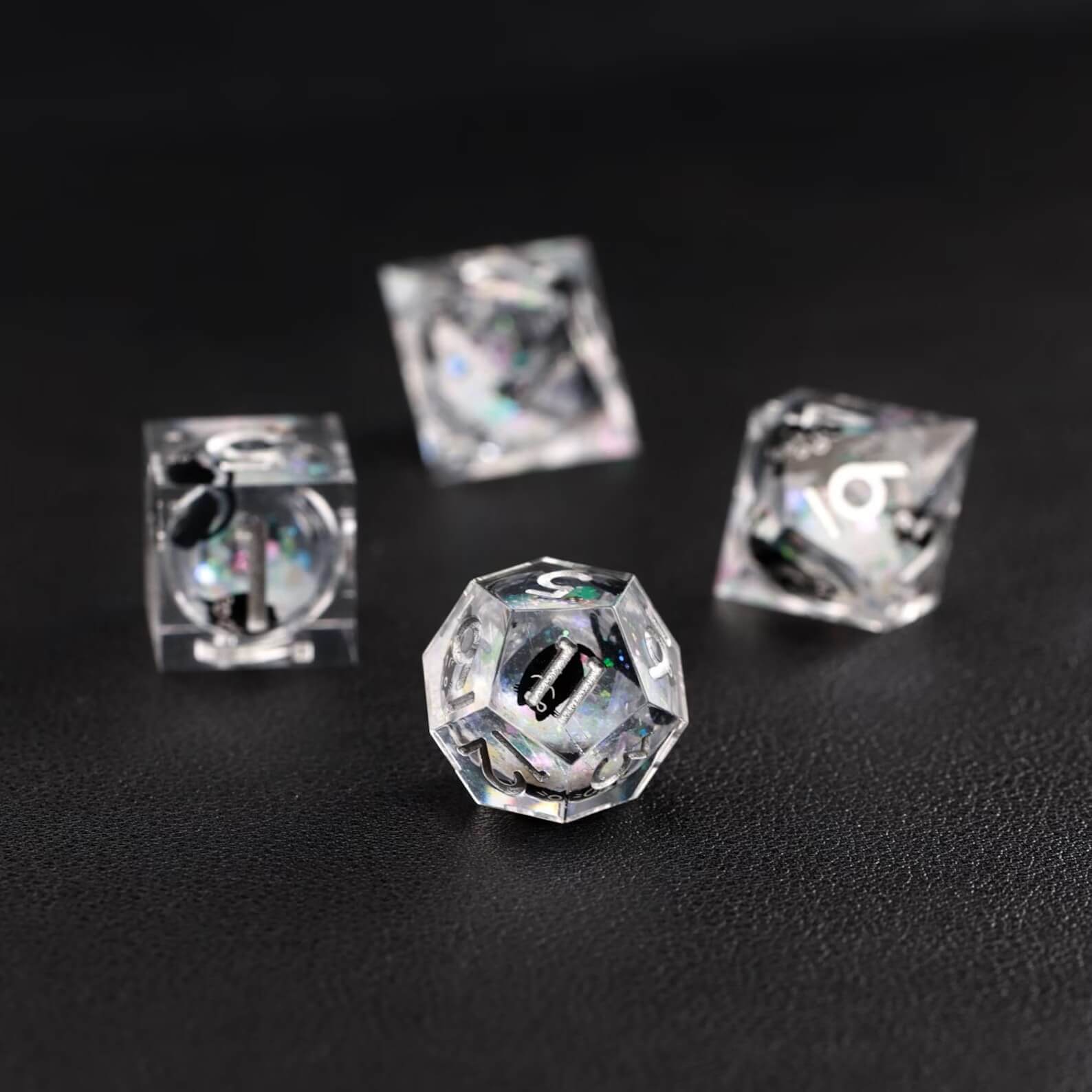 Assortment of polyhedral shapes in the Liquid Core Dice Resin Set with the animal dice feature.
