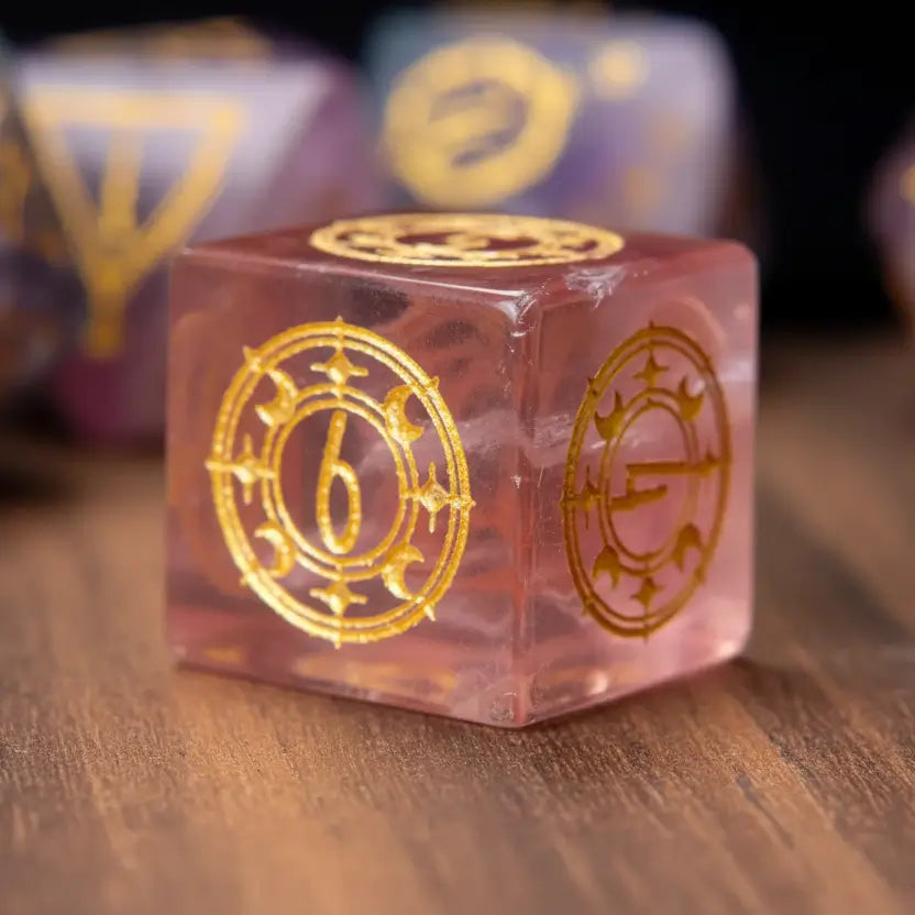 Single purple fluorite D6 dice with engraved pips, resting on the warm-toned surface of a walnut wood table.