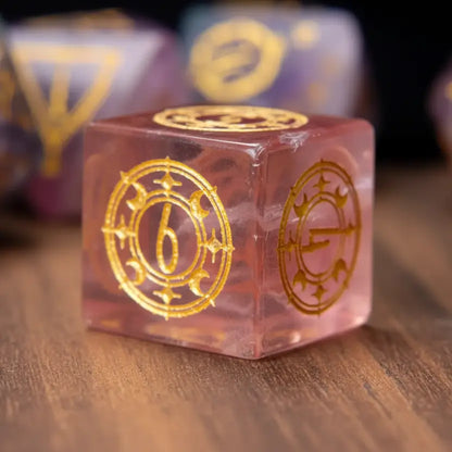 Single purple fluorite D6 dice with engraved pips, resting on the warm-toned surface of a walnut wood table.